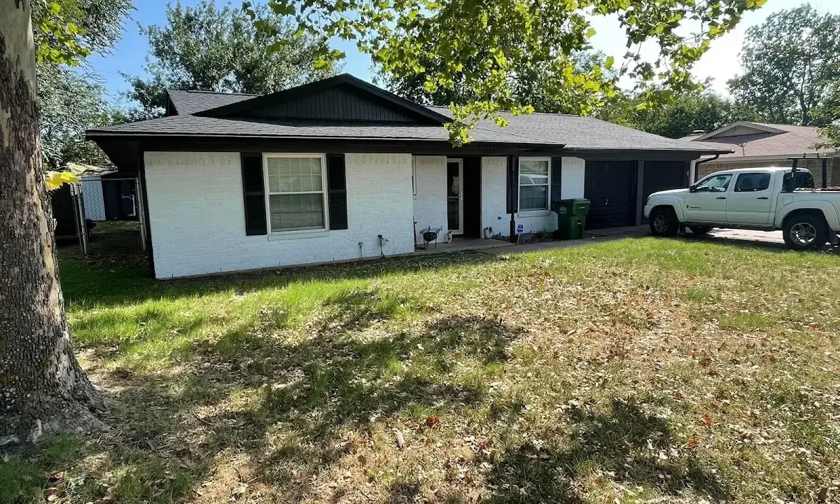 Professional roofing crew working on a residential roof in Denton